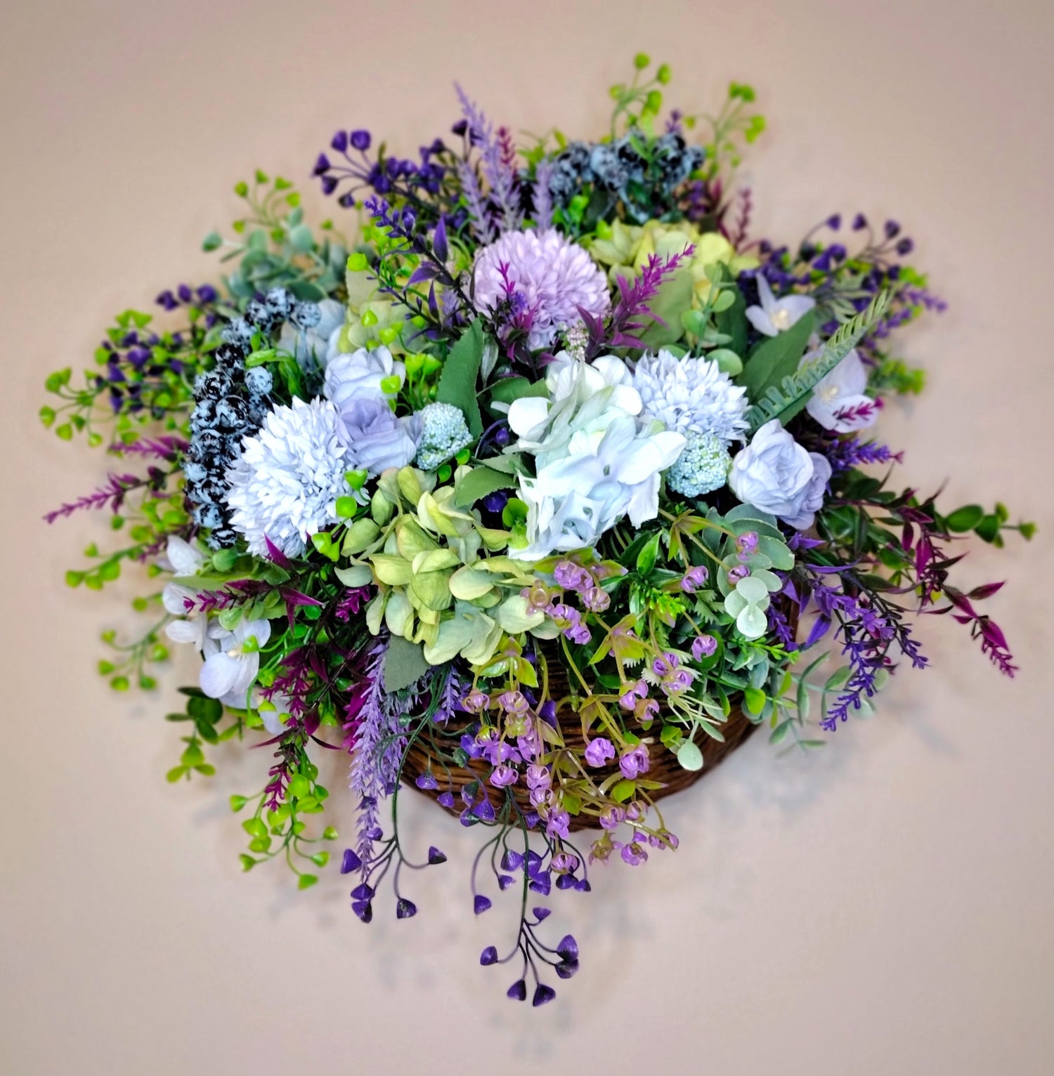 Artificial flower arrangements in a WALL HANGING BASKETS