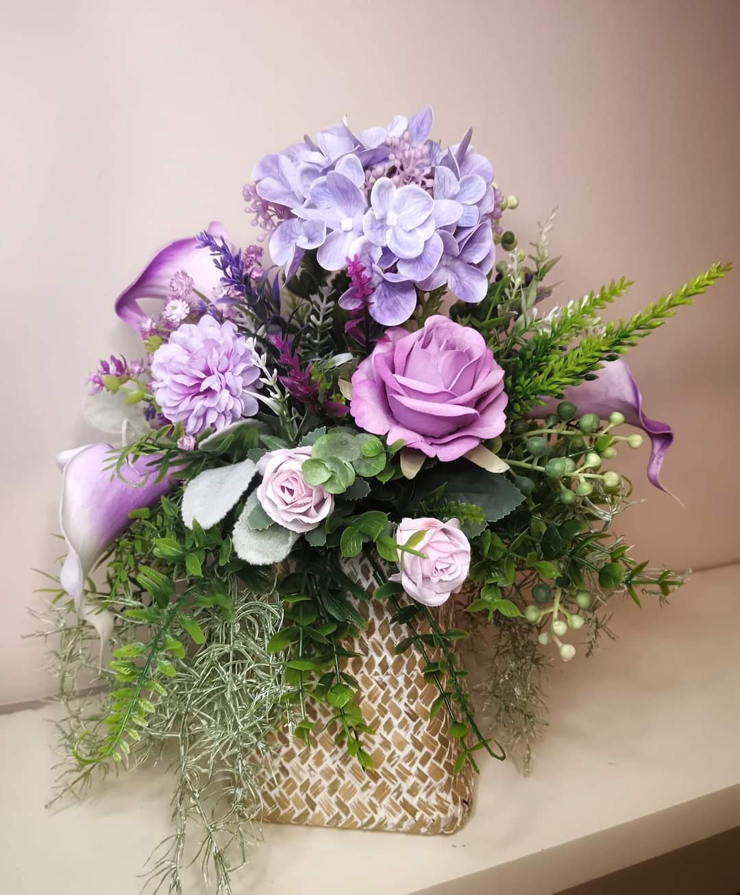 Artificial flower arrangements in a FREE STANDING BASKETS