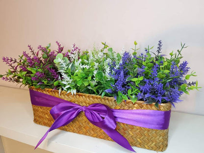 Artificial flowers in a woven basket A1