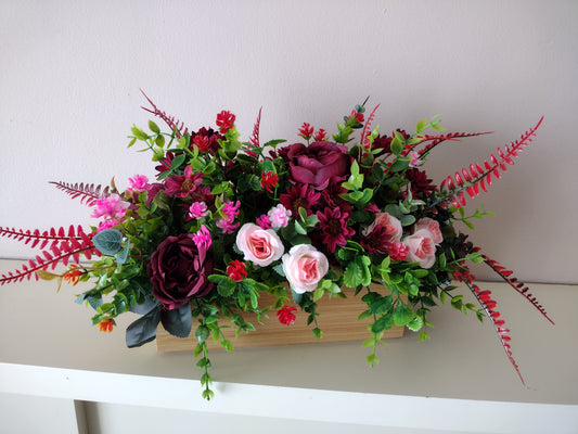 Artificial flowers in a wooden box O