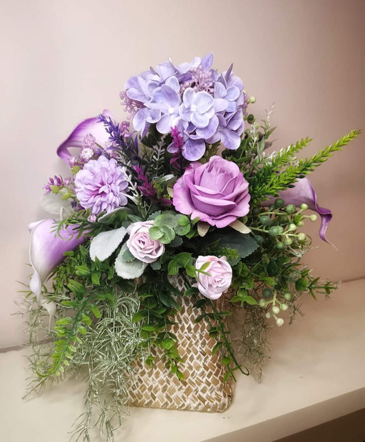 Artificial flower bouquet in a woven vase R