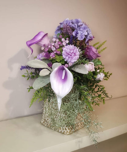 Artificial flower bouquet in a woven vase R