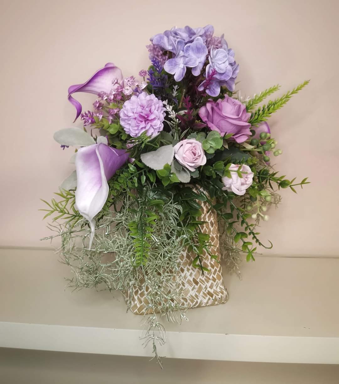 Artificial flower bouquet in a woven vase R