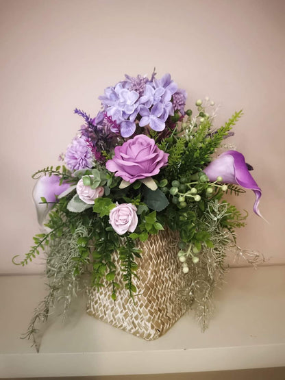 Artificial flower bouquet in a woven vase R