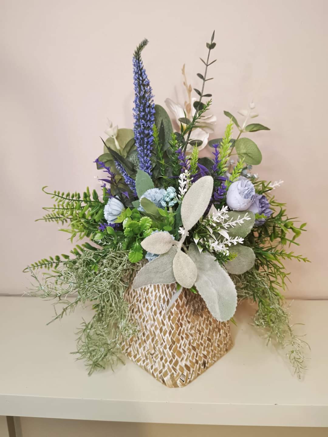 Artificial flower bouquet in a woven vase U