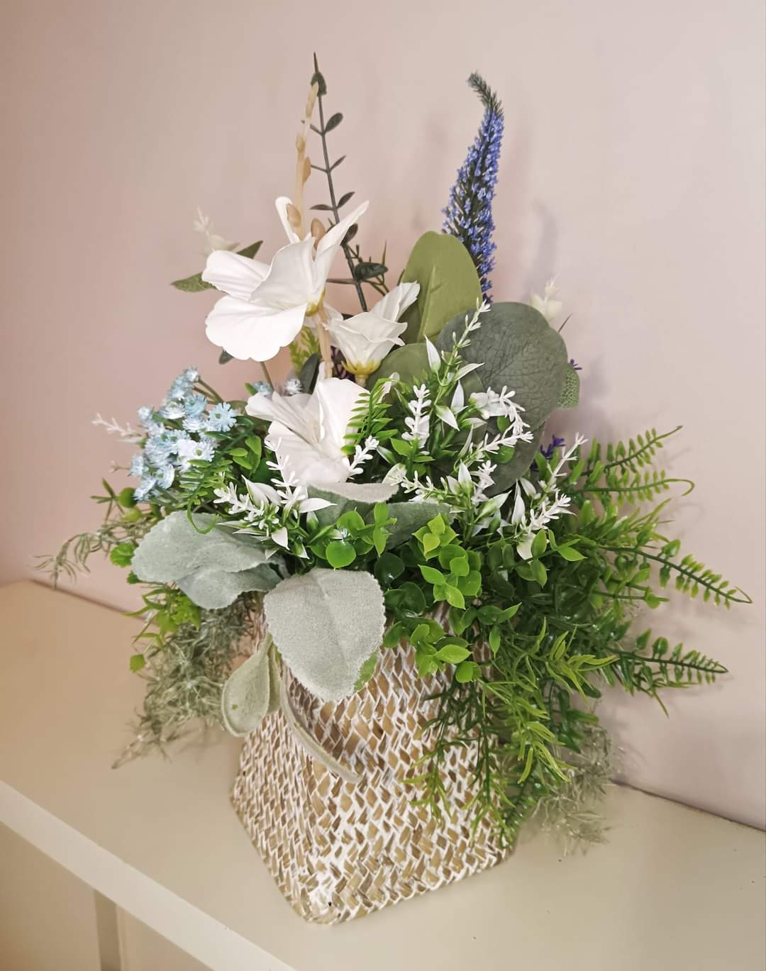 Artificial flower bouquet in a woven vase U