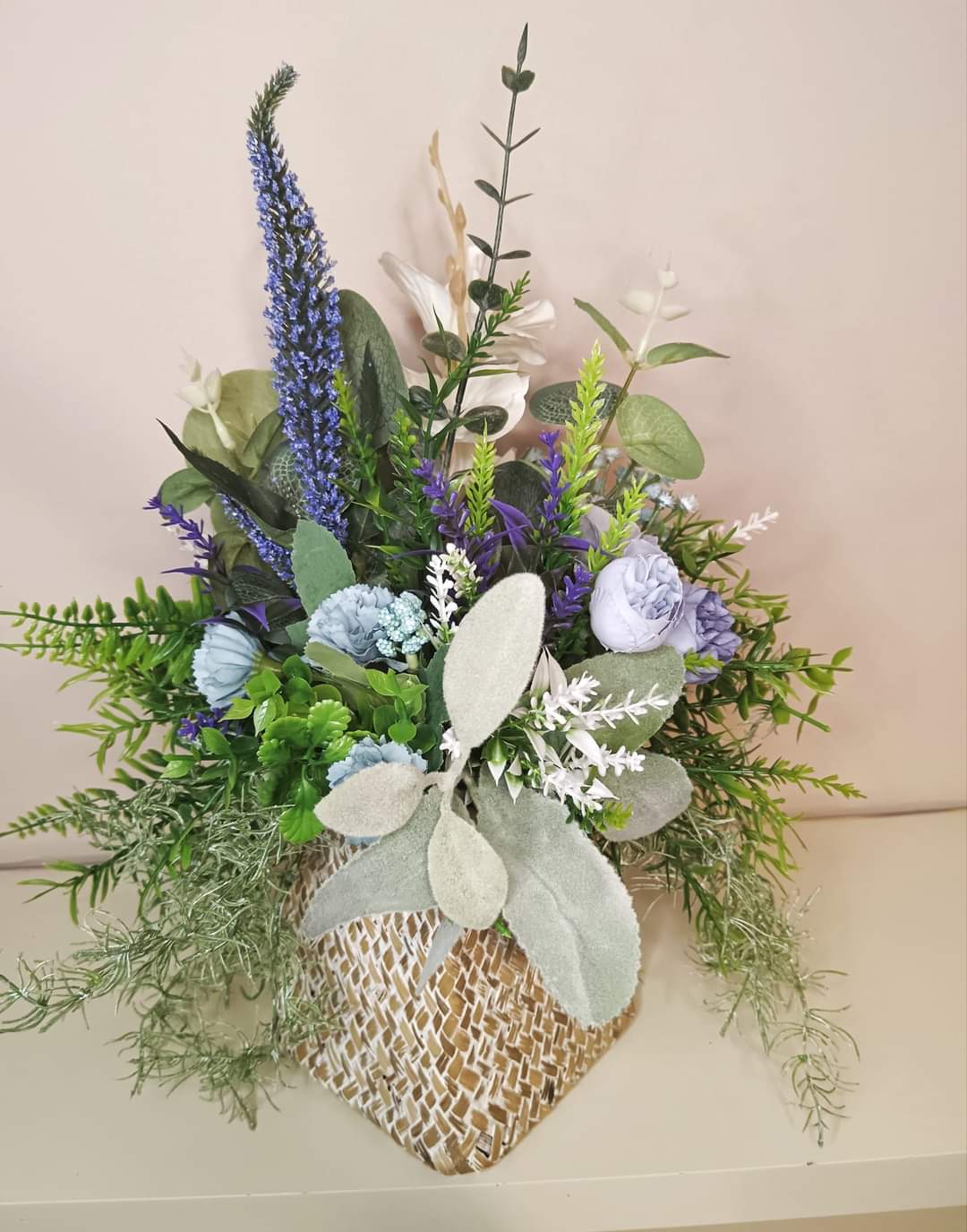 Artificial flower bouquet in a woven vase U