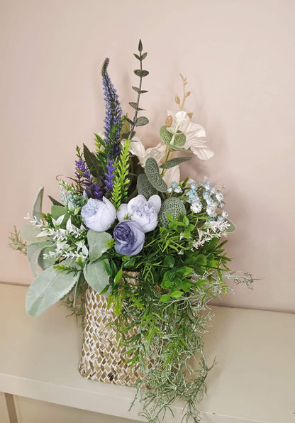 Artificial flower bouquet in a woven vase U