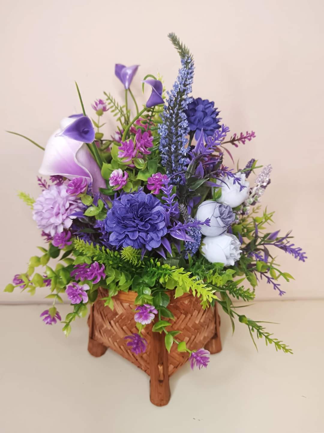 Artificial flower bouquet in a mini basket Y