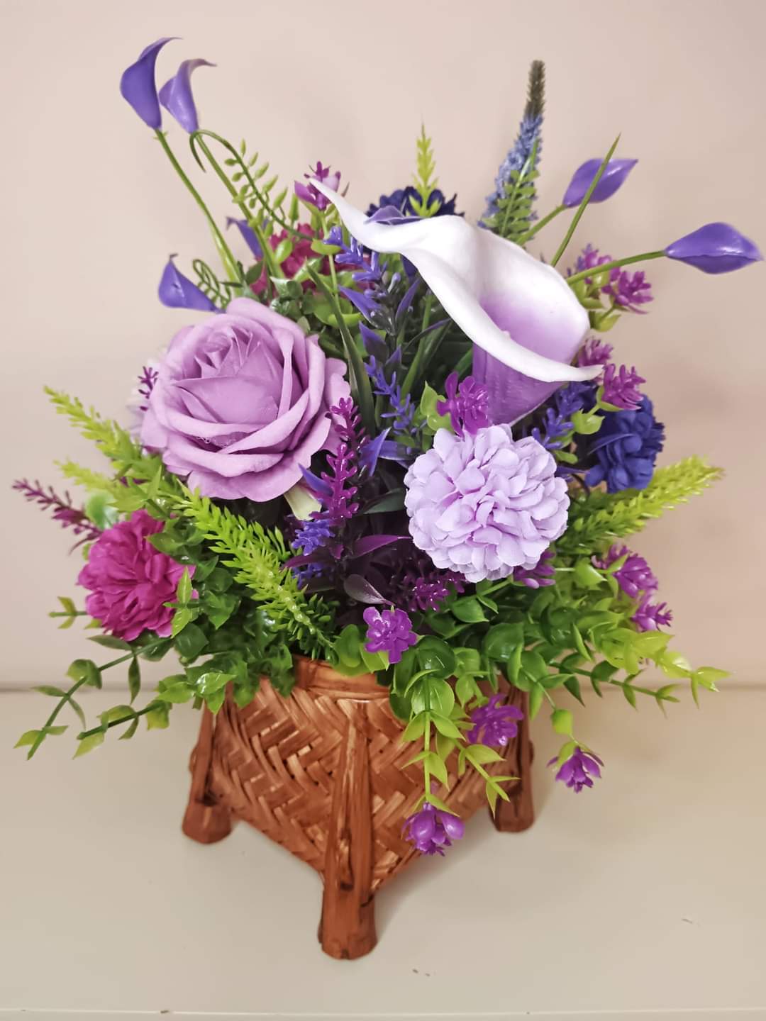 Artificial flower bouquet in a mini basket Y