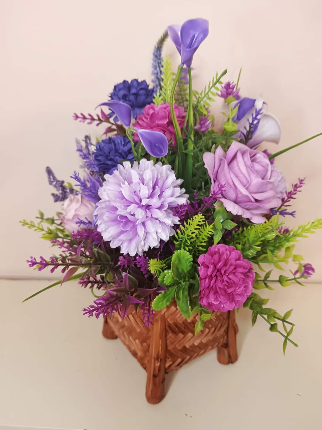 Artificial flower bouquet in a mini basket Y